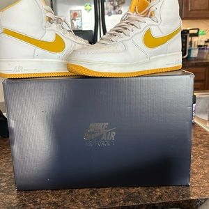 Slight worn and previously loved Nike Air Force 1 white and yellow high-top.